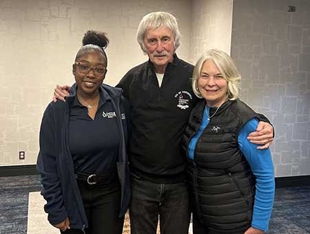 CIS Founder Bill Milliken poses with his wife Jean and CIS Alum Kai