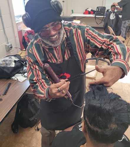 Barber cutting a student's hair